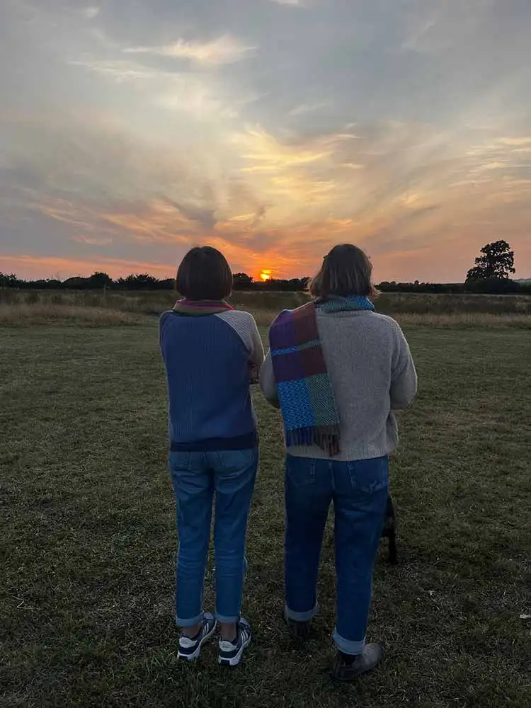 two campers watching the sunset